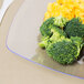 A Fineline clear plastic plate with broccoli and cheese on it.