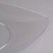 A clear plastic Fineline Renaissance plate with a curved edge.