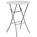 A white round Flash Furniture folding table with metal legs.