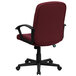 A burgundy office chair with black arms and a black base.