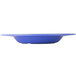 A Carlisle Ocean Blue melamine bowl on a table.
