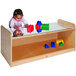 A child playing with blocks on a Whitney Brothers play table with a mirror top.