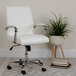 A white Flash Furniture office chair with chrome arms next to a potted plant.