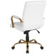 A white office chair with gold legs and arms.