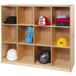 A Whitney Brothers wooden cubby storage cabinet with white cubbies holding hats and clothes.