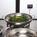 An American Metalcraft stainless steel serving pan with asparagus and a lemon wedge.