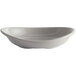 A curved white Carlisle pasta bowl with a shadow.