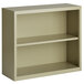 A putty Hirsh welded steel bookcase with two shelves.