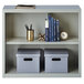 A light gray Hirsh 2-shelf steel bookcase with books on the top shelf.