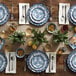 A table set with a stack of American Metalcraft blue and white floral melamine bread and butter plates.