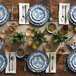 A table set with a stack of American Metalcraft Isabella melamine plates with a blue and white floral design.