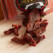 A bag of Uncle Mike's Original beef jerky on a table with a wooden cutting board.