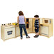 A woman and boy playing with a Whitney Brothers natural wood toy kitchen set.