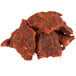 A pile of Uncle Mike's spicy hot beef jerky on a white background.