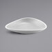 A white triangle melamine serving bowl with a speckled surface.
