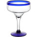 A clear Acopa margarita glass with a blue rim and base.