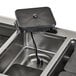 A black Vollrath drop-in hot food well with a black plug.