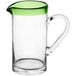 An Acopa glass pitcher with a green rim and handle.