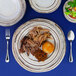 An Elite Global Solutions Doheny melamine plate with meat, vegetables, and a fork.