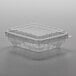 A 6 oz. clear plastic clamshell produce container with a clear lid.