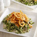 A plate of green beans and French's Crispy Fried Onions on a white plate.