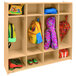 A Whitney Brothers wooden classroom coat locker with bags and backpacks inside.