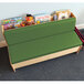 A green cushioned bench with books on top.