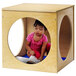 A child playing in a Whitney Brothers wooden play house cube.