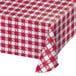 A red and white checkered Creative Converting paper tablecloth on a table.