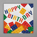 A white 2-ply napkin with colorful block letters reading "Happy Birthday" surrounded by colorful block shapes.