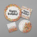 A white paper plate with colorful sprinkles and black "Happy Birthday" text.
