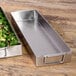 Two Elite Global Solutions rectangular stainless steel trays with food on a counter.
