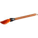 An Outset silicone BBQ mop brush with a rosewood handle and orange bristles.