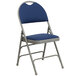 A navy blue metal folding chair with a navy blue padded seat.