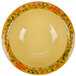 A yellow Venetian bowl with a floral design.