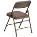 A beige metal folding chair with a padded seat.