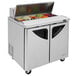 A Turbo Air stainless steel refrigerated sandwich prep table with two doors and a drawer.