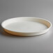 A white round plastic tray with a circle in the middle.