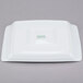 A white square tray with green writing that says "Arcoroc"
