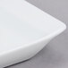 An Arcoroc white rectangular tray with rounded edges.