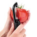 A person using the OXO Straight Vegetable Peeler to peel a tomato.