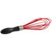 An OXO Good Grips whisk with a black handle and red accents.
