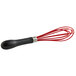 An OXO Good Grips red and black silicone whisk with a black handle.