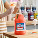 A gallon jug of Carnival King Egg Custard Snow Cone Flavoring Syrup with a pump dispenser.