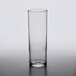 An Arcoroc highball glass on a white surface.