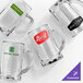 A set of four clear glass beer mugs, each with a different customizable logo or design on the front.