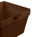 A brown square cast aluminum container with a lid.