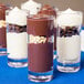 A group of GET plastic dessert shot glasses filled with chocolate and peanut butter cups.