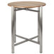 A round Bon Chef table top with metal and wood.