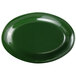 A green oval melamine platter with a white circle in the middle.
